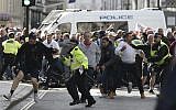 Police stop a breakaway from the main Football Lads alliance march, as they attempt to get close to a rival anti-fascist demonstration in London, Saturday, October 13, 2018 (AP Photo/Alastair Grant)