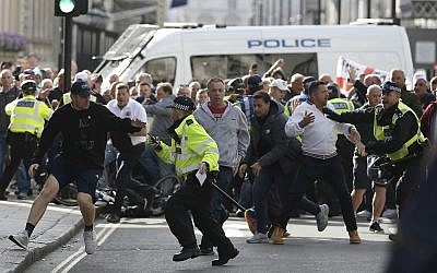 Police stop a breakaway from the main Football Lads alliance march, as they attempt to get close to a rival anti-fascist demonstration in London, Saturday, October 13, 2018 (AP Photo/Alastair Grant)