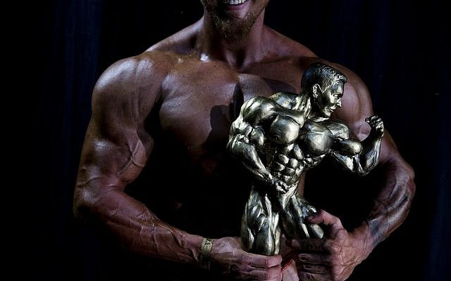 Or Magdasi of Tel Aviv, holds his trophy after winning the National Amateur Body Builders' Association competition in the Mens category, in Tel Aviv, Israel, October 18, 2018. (Oded Balilty/AP)