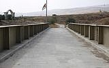 A Jordanian flag hangs on a bridge leading from Israel to Jordan in the Jordan valley area called Naharayim, or Baqura in Arabic, in northern Israel, Monday, Oct. 22, 2018 (AP Photo/Ariel Schalit)