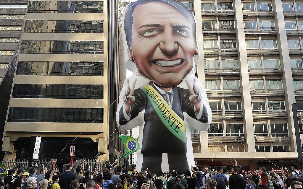 In this Sept. 9, 2018 file photo, supporters of presidential frontrunner Jair Bolsonaro, exhibit a large, inflatable doll in his image as they march along Paulista Avenue to show support for him in Sao Paulo, Brazil. (AP Photo/Andre Penner) In this Sept. 9, 2018 file photo, supporters of presidential frontrunner Jair Bolsonaro, exhibit a large, inflatable doll in his image as they march along Paulista Avenue to show support for him in Sao Paulo, Brazil. (AP Photo/Andre Penner)