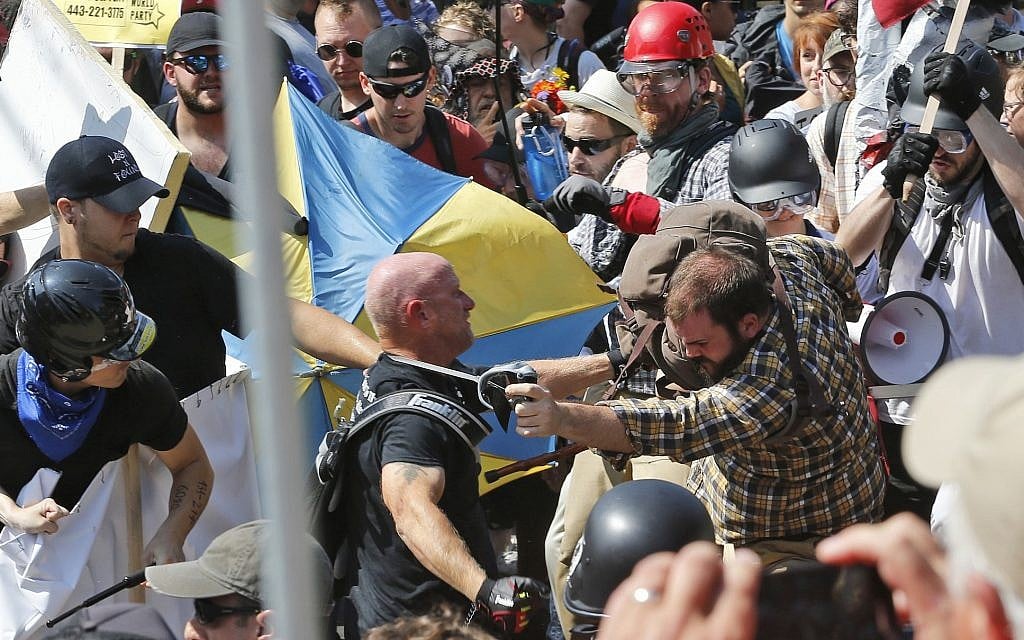 Illustrative: In this photo from August 12, 2017, white supremacist demonstrators clash with counter demonstrators at the entrance to Lee Park in Charlottesville, Virginia. (AP Photo/Steve Helber, File) Illustrative: In this photo from August 12, 2017, white supremacist demonstrators clash with counter demonstrators at the entrance to Lee Park in Charlottesville, Virginia. (AP Photo/Steve Helber, File)