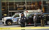 An officer keeps watch in front of the Time Warner Building, where NYPD personnel removed an explosive device Wednesday, Oct. 24, 2018, in New York. (AP Photo/Kevin Hagen)