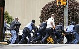 Law enforcement run with a person on a stretcher at the scene where multiple people were shot, October 27, 2018, at the Tree of Life Congregation in Pittsburgh's Squirrel Hill neighborhood. (Alexandra Wimley/Pittsburgh Post-Gazette via AP)