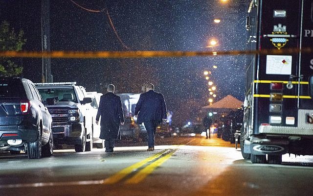 The FBI investigates in the rain after a deadly shooting at the Tree of Life Congregation, a Conservative synagogue, on Saturday, October 27, 2018, in the Squirrel Hill section of Pittsburgh, Pennsylvania. (Andrew Stein/Pittsburgh Post-Gazette via AP) The FBI investigates in the rain after a deadly shooting at the Tree of Life Congregation, a Conservative synagogue, on Saturday, October 27, 2018, in the Squirrel Hill section of Pittsburgh, Pennsylvania. (Andrew Stein/Pittsburgh Post-Gazette via AP)