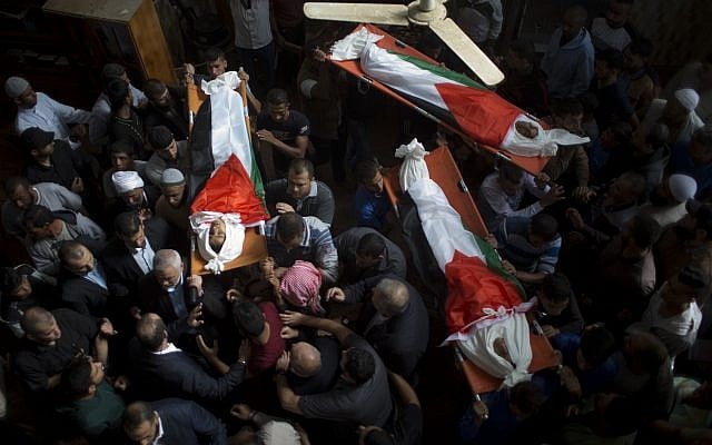 Mourners carry the bodies of three teens, wrapped in Palestinian flags, who were killed in an Israeli airstrike during their funeral in the town of Deir el-Balah, central Gaza Strip, October 29, 2018. (Khalil Hamra/AP) Mourners carry the bodies of three teens, wrapped in Palestinian flags, who were killed in an Israeli airstrike during their funeral in the town of Deir el-Balah, central Gaza Strip, October 29, 2018. (Khalil Hamra/AP)