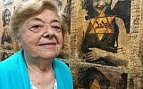In this October 29, 2018 photo, Auschwitz-Birkenau survivor Magda Brown, 91, stands beside an image of Anne Frank at the Holocaust Center of Pittsburgh. (AP Photo/Allen G. Breed)