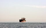 Illustrative -- A cargo ship is seen between Iranian city port of Bandar Abbas and Qeshm island in the strategic water way of Persian Gulf, on Dec. 23, 2011. (AP Photo/Vahid Salemi)