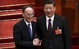 Chinese President Xi Jinping, right, shakes hands with Wang Qishan after Wang was elected vice-president during a plenary session of China's National People's Congress (NPC) in Beijing, March 17, 2018. (AP Photo/Mark Schiefelbein)