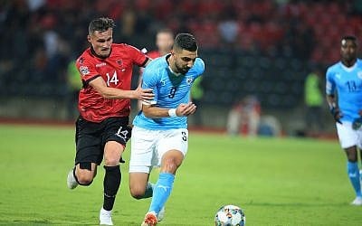 Albania's Taulant Xhaka,, left, fights for the ball with Israel's Munas Dabbur during the UEFA Nations League soccer match between Albania and Israel at Elbasan Arena, in Elbasan, southern Albania, Sept. 7, 2018. (AP Photo/Hektor Pustina)