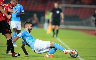 Albania's Taulant Xhaka ,left, fights for the ball with Israel's Munas Dabbur during the UEFA Nations League soccer match between Albania and Israel at Elbasan Arena, in Elbasan, southern Albania, September 7, 2018. (AP Photo/Hektor Pustina)