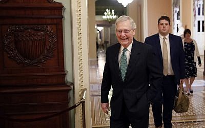 Senate Majority Leader Mitch McConnell of Ky., left, walks out of his office on Capitol Hill, Wednesday, Oct. 3, 2018 in Washington. (AP Photo/Alex Brandon)