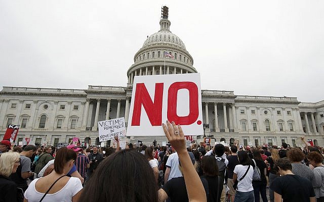 Activists demonstrate in the plaza of the East Front of the US Capitol to protest the confirmation vote of Supreme Court nominee Brett Kavanaugh on Capitol Hill, Oct. 6, 2018 in Washington. (AP Photo/Alex Brandon)