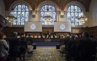 In this Wednesday Oct. 3, 2018, image The delegations of the US, front left, and the Islamic Republic of Iran, front right, rise as judges, rear, enter the International Court of Justice, or World Court, in The Hague, Netherlands.(AP/Peter Dejong)