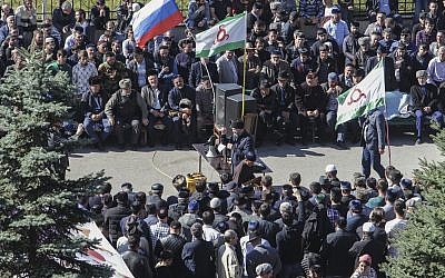People attend a protest against the new land swap deal agreed by the heads of the Russian regions of Ingushetia and Chechnya, in Ingushetia's capital Magas, Russia, Oct. 8, 2018 (AP Photo/Musa Sadulayev)