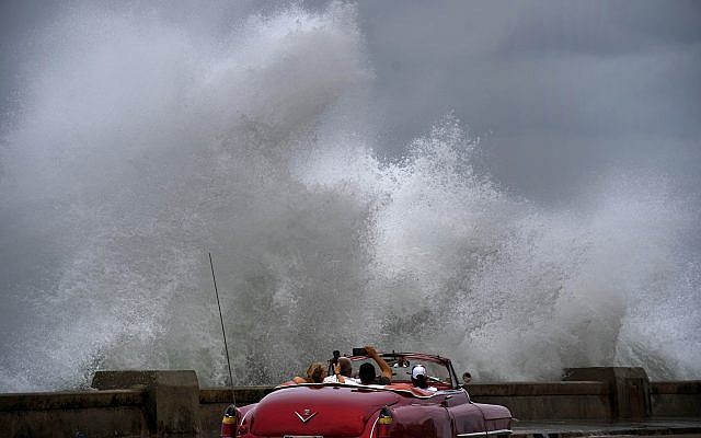 Waves crash against the Malecon, triggered by the outer bands of Hurricane Michael, as tourists drive past in a classic American car in Havana, Cuba, October 9, 2018. (AP Photo/Ramon Espinosa) Waves crash against the Malecon, triggered by the outer bands of Hurricane Michael, as tourists drive past in a classic American car in Havana, Cuba, October 9, 2018. (AP Photo/Ramon Espinosa)