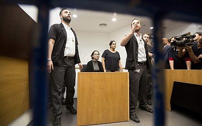American Lara Alqasem, center, sits in a courtroom prior to a hearing at the district court in Tel Aviv, Israel, Thursday, Oct. 11, 2018.(AP Photo/Sebastian Scheiner)
