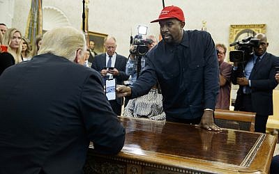Rapper Kanye West shows then US president Donald Trump a photograph of a hydrogen plane during a meeting in the Oval Office of the White House October 11, 2018, in Washington. (AP Photo/Evan Vucci)