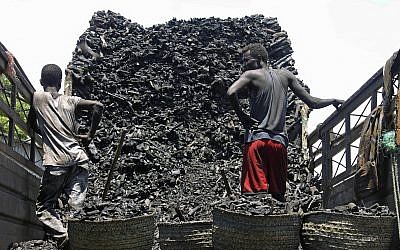 In this Tuesday Oct. 30, 2012 File photo, Somali porters offload charcoal from a truck at a charcoal market in Mogadishu, Somali (AP Photo/Farah Abdi Warsameh)