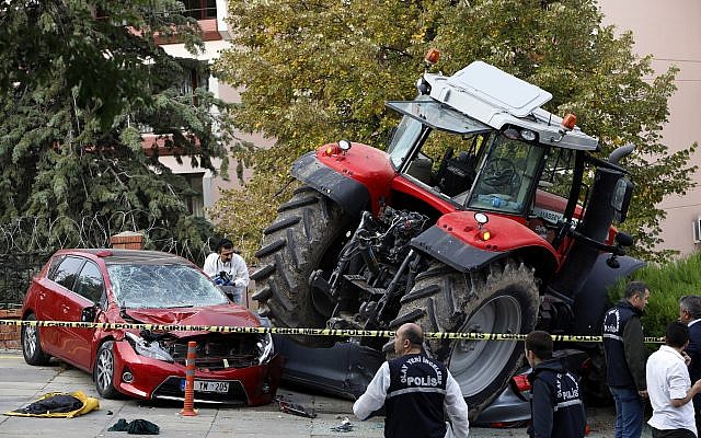 Forensic officers work at the scene after a tractor crashed into cars outside a residence, in Ankara, Turkey, Oct. 16, 2018 (AP Photo/Burhan Ozbilici) Forensic officers work at the scene after a tractor crashed into cars outside a residence, in Ankara, Turkey, Oct. 16, 2018 (AP Photo/Burhan Ozbilici)