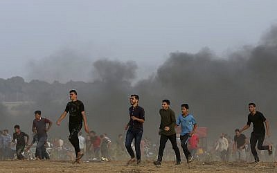 Protesters near the Gaza Strip border with Israel east of Khan Younis, southern Gaza Strip, Friday, October 19, 2018. (AP Photo/Adel Hana)