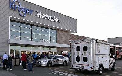 Employees wait outside the entrance of a Kroger grocery following a shooting that left two people dead and a suspect in custody, Wednesday, Oct. 24, 2018, in Jeffersontown, Ky. A man fatally shot another man inside a Kroger grocery store, shot and killed a woman in the parking lot, and then exchanged fire with an armed bystander who intervened before he fled the scene on the outskirts of Louisville, Kentucky, on Wednesday, police said. He was captured shortly afterward. (AP Photo/Timothy D. Easley) Employees wait outside the entrance of a Kroger grocery following a shooting that left two people dead and a suspect in custody, Wednesday, Oct. 24, 2018, in Jeffersontown, Ky. A man fatally shot another man inside a Kroger grocery store, shot and killed a woman in the parking lot, and then exchanged fire with an armed bystander who intervened before he fled the scene on the outskirts of Louisville, Kentucky, on Wednesday, police said. He was captured shortly afterward. (AP Photo/Timothy D. Easley)