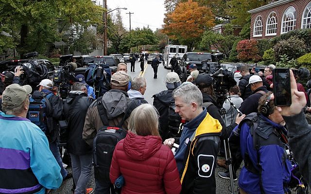 A crowd of media wait in the street two blocks from the Tree of Life Synagogue in Pittsburgh, where a shooter killed 11 people on Saturday, Oct. 27, 2018. (AP/Gene J. Puskar)