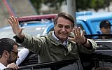 Jair Bolsonaro, then a presidential candidate with the Social Liberal Party, waves after voting in the presidential runoff election in Rio de Janeiro, Brazil, October 28, 2018. (AP Photo/Silvia izquierdo)