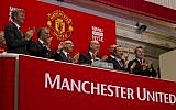 Executives from Manchester United, including Avram Glazer, fourth from left, and Joel Glazer, third from left, applaud after ringing the opening bell at the New York Stock Exchange on August 10, 2012 in New York. (AP/Jin Lee)