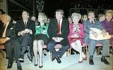Donald Trump, center, sits with hands folded at the Trump Taj Mahal in Atlantic City, New Jersey, April 6, 1990, before the start of grand opening ceremonies. Trump (C) attended the gala with his parents, Mary (3rd R) and Fred (2nd R), and sister US District Court Judge Maryanne Trump Barry (R), and brother Robert Trump (L) and his wife Blaine Trump (3rd L). Trump was dateless. (AP Photo/Charles Rex Arbogast)