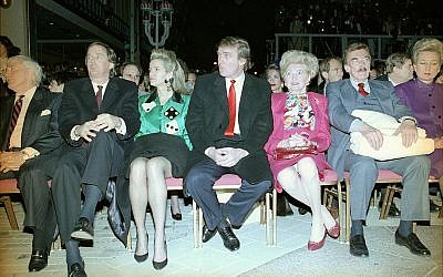 Donald Trump, center, sits with hands folded at the Trump Taj Mahal in Atlantic City, New Jersey, April 6, 1990, before the start of grand opening ceremonies. Trump (C) attended the gala with his parents, Mary (3rd R) and Fred (2nd R), and sister US District Court Judge Maryanne Trump Barry (R), and brother Robert Trump (L) and his wife Blaine Trump (3rd L). Trump was dateless. (AP Photo/Charles Rex Arbogast)