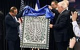 US Ambassador to Israel David Friedman, right, and Israel's Communications Minister Ayoub Kara unveil the Israel Post and US Postal Service joint stamp for Hanukkah at the American Center, Jerusalem, October 16, 2018. (Matty Stern/US Embassy Jerusalem)