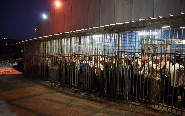 Palestinian workers wait to cross a checkpoint to work in Israel at the security barrier in the West Bank city of Bethlehem, on August 23, 2010. (Najeh Hashlamoun/Flash 90) Palestinian workers wait to cross a checkpoint to work in Israel at the security barrier in the West Bank city of Bethlehem, on August 23, 2010. (Najeh Hashlamoun/Flash 90)