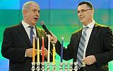 Prime Minister Benjamin Netanyahu (L) and then education minister Gideon Sa'ar light candles to celebrate the Jewish holiday of Hanukkah during the Bible Quiz at the International Conference Center in Jerusalem, on December 12, 2012. (Miriam Alster/Flash90)
