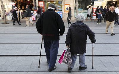 An elderly couple walk on Jaffa street in downtown Jerusalem on February 20, 2017. (Nati Shohat/Flash90)