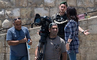 A police officer blocks media from entering the Old City, outside the Lion's Gate in Jerusalem's Old City, July 23, 2017. (Yonatan Sindel/Flash90)