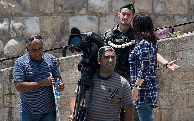 A police officer blocks media from entering the Old City, outside the Lion's Gate in Jerusalem's Old City, July 23, 2017. (Yonatan Sindel/Flash90) A police officer blocks media from entering the Old City, outside the Lion's Gate in Jerusalem's Old City, July 23, 2017. (Yonatan Sindel/Flash90)