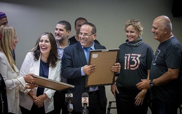 Communications Minister Ayoub Kara with representatives of the Reshet (R) and Keshet (L) media companies during a ceremony awarding broadcasting licenses for new channels 12 and 13 in Jerusalem, following Channel 2's split, on October 31, 2017. (Yonatan Sindel/Flash90) Communications Minister Ayoub Kara with representatives of the Reshet (R) and Keshet (L) media companies during a ceremony awarding broadcasting licenses for new channels 12 and 13 in Jerusalem, following Channel 2's split, on October 31, 2017. (Yonatan Sindel/Flash90)
