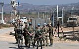 UN peacekeepers and Israeli soldiers are seen on the Israeli side of the Quneitra Crossing between Israel and Syria in the Golan Heights on September 27, 2018. (Basel Awidat/Flash90)