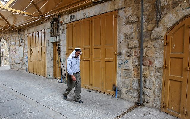 A Palestinian man walks past closed shops in the Old City of Hebron, due to a general strike in response to Israel's Nation State Law on October 1, 2018 (Wisam Hashlamoun/Flash90) A Palestinian man walks past closed shops in the Old City of Hebron, due to a general strike in response to Israel's Nation State Law on October 1, 2018 (Wisam Hashlamoun/Flash90)