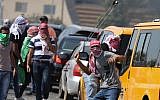 Illustrative: Palestinian demonstrators clash with Israeli troops during clashes near the Jewish settlement of Beit El, near Ramallah on October 2, 2018. (Flash90)