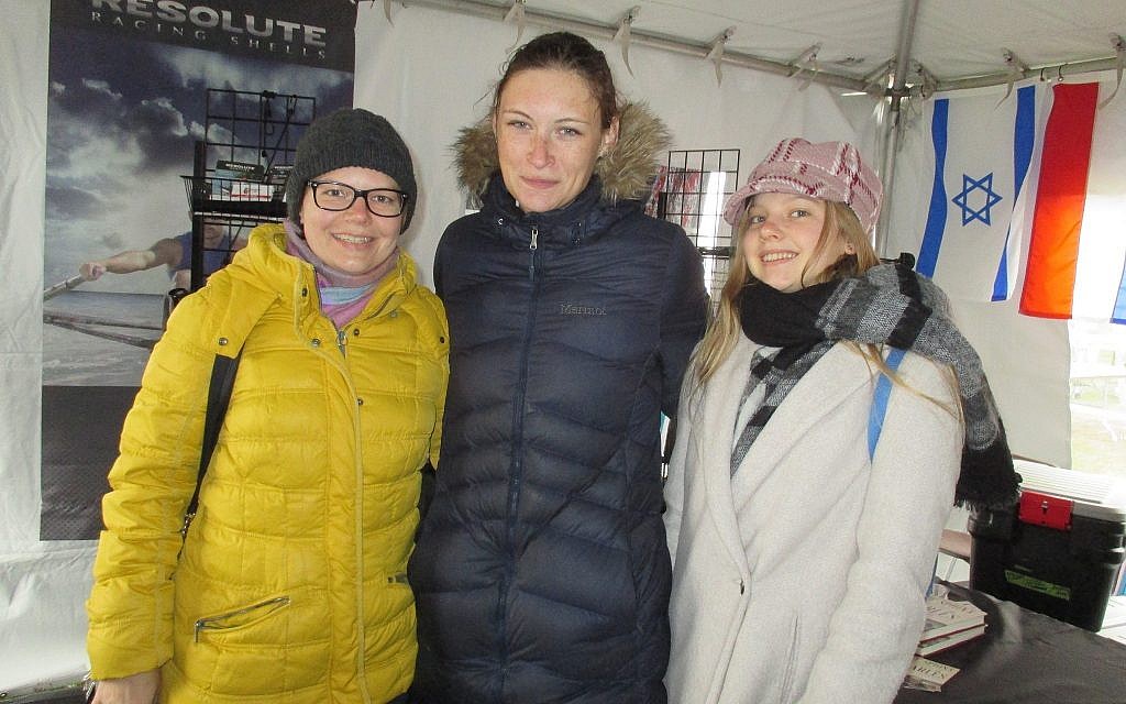 Michal Spalter (center) bundled up in a warm jacket after her race, was greeted by Anna Rosinska, a Polish cousin who is a visiting scholar at the University of Massachusetts at Lowell. Spalter's parents, who live in Tel Aviv, were originally from Poland, the home of her coach. (Penny Schwartz/ Times of Israel)