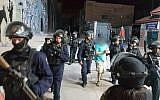 Illustrative: Members of Israeli security forces arrest a Palestinian suspected of hurling a pipe bomb at Rachel's Tomb, in the al-Ayda refugee camp in the West Bank, on October 4, 2018. (Israel Police)