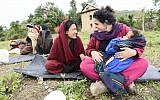 A volunteer and a local share a laugh during a women's group meeting in Managua, Nepal, in 2015. (Courtesy Tevel B'Tzedek)