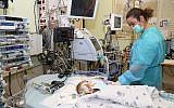Musa, a Palestinian baby from the West Bank, clings to life at Sheba Medical Center in Tel Aviv after receiving a new heart donated from an Israeli child. (Sheba Medical Center)