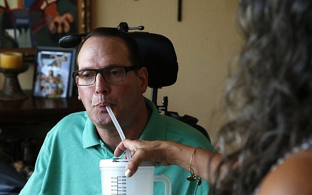 A man with multiple sclerosis gets help drinking water, August 21, 2015. (AP Photo/Brennan Linsley) A man with multiple sclerosis gets help drinking water, August 21, 2015. (AP Photo/Brennan Linsley)