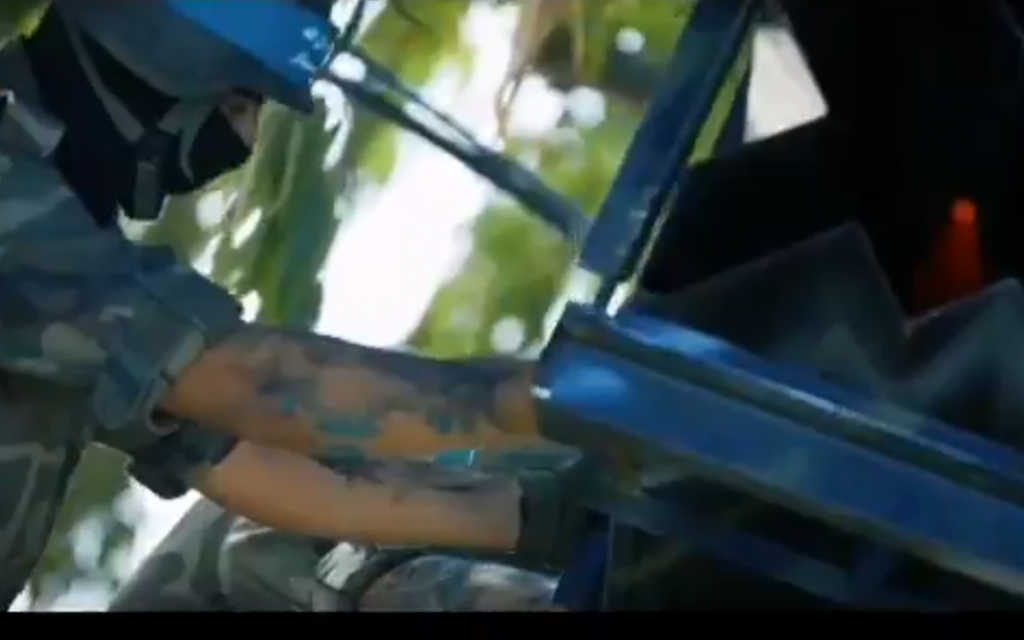 A screenshot from a video published by Hamas on October 18, 2018, appearing to show a member preparing a rocket for launch.