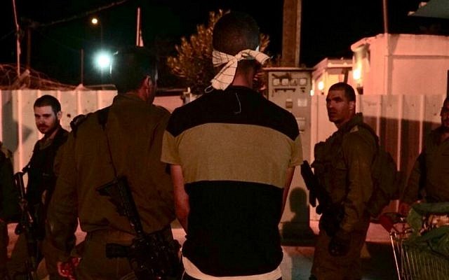 Israeli soldiers arrest the suspect in the stabbing of an army reservist outside an IDF base in the northern West Bank, October 12, 2018. (Nasser Ishtayeh/Flash90) Israeli soldiers arrest the suspect in the stabbing of an army reservist outside an IDF base in the northern West Bank, October 12, 2018. (Nasser Ishtayeh/Flash90)