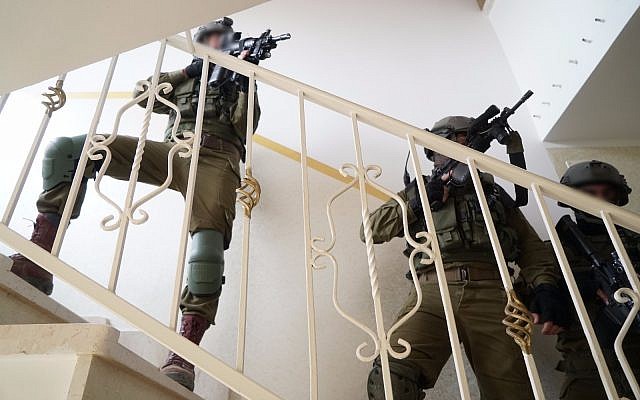 Israeli troops raid the home of Ashraf Walid Suleiman Na’alowa in the northern West Bank village of Shuweika, on October 7, 2018. (Israel Defense Forces) Israeli troops raid the home of Ashraf Walid Suleiman Na’alowa in the northern West Bank village of Shuweika, on October 7, 2018. (Israel Defense Forces)