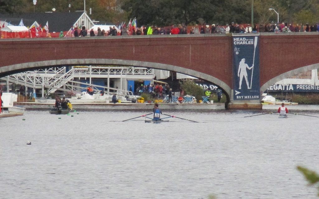 Damp and cold weather didn't keep fans from cheering racers from the Eliot Bridge in Cambridge, at the Head of the Charles Regatta, where some 300,000 spectators turned out for the two-day race. (Penny Schwartz/ Times of Israel)